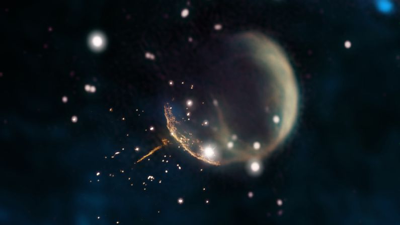 The ghostly shell in this image is a supernova, and the glowing trail leading away from it is a pulsar.