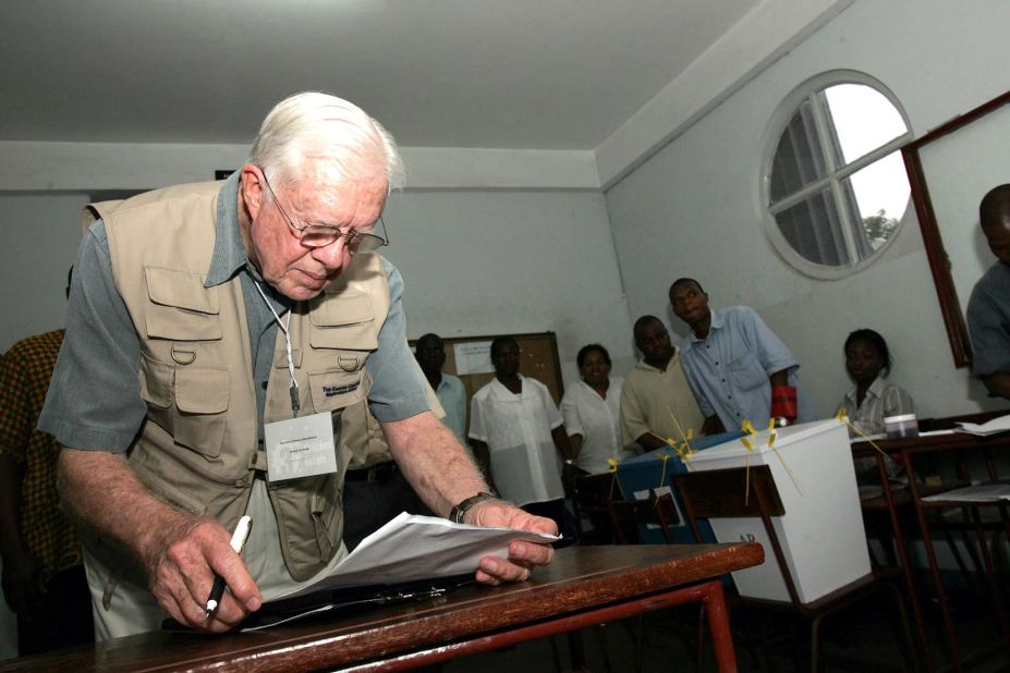 Carter checks his notes while observing a polling station in Maputo, Mozambique, in December 2004. Since 1989, the Carter Center has been observing elections around the world to determine their legitimacy. The nonprofit organization was founded by Carter and his wife to advance human rights across the globe.