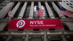 American flags fly above Pinterest Inc. signage outside the New York Stock Exchange (NYSE) in New York, U.S., on Friday, Feb. 9, 2018. The convulsions rocking U.S. equity markets continued Friday, with major indexes headed for the worst week in almost seven years after falling back from early gains. Treasury declines eased as investors sought havens from gold to the yen. Photographer: Michael Nagle/Bloomberg via Getty Images