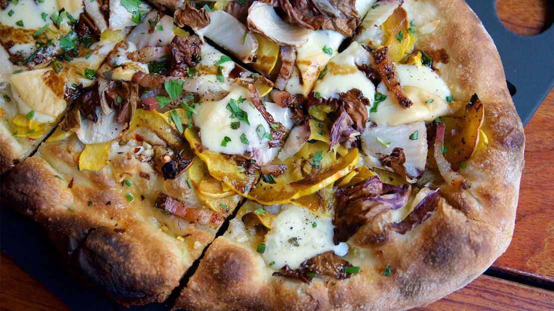 A pizza of delicata squash, radicchio, scamorza cheese and house bacon.