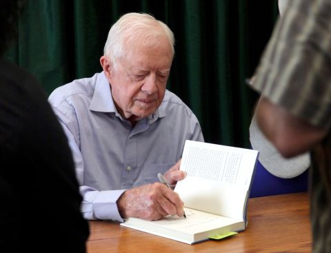 Carter signs his book "A Full Life: Reflections At Ninety" in Pasadena, California, in July 2015.