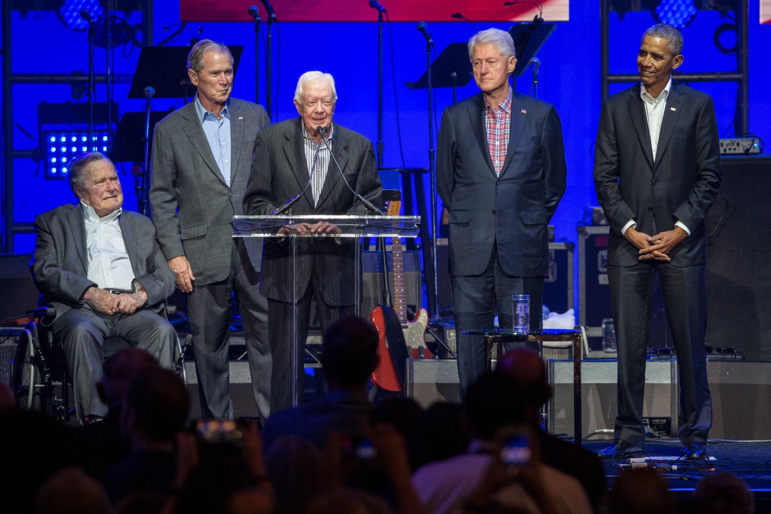 Carter, center, speaks alongside other former US presidents as they attend a Hurricane Relief concert in College Station, Texas, in October 2017.