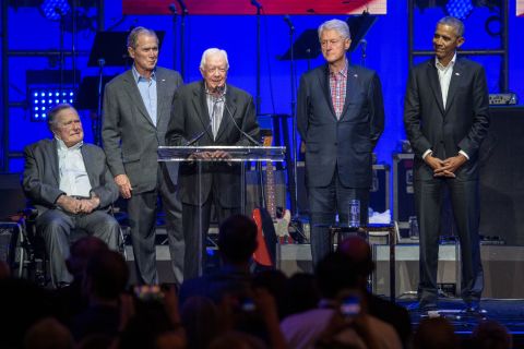Carter, center, speaks along side former US Presidents George H. W. Bush, George W. Bush, Bill Clinton and Barack Obama as they attend the Hurricane Relief concert in College Station, Texas, in October 2017.