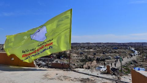 A picture taken on March 23, 2019 shows the US-backed Syrian Democratic Forces' (SDF) flag atop a building in the Islamic State group's last bastion in the eastern Syrian village of Baghuz after defeating the jihadist group. - The Kurdish-led forces pronounced the death of the Islamic State group's nearly five-year-old "caliphate" on March 23, 2019 after flushing out diehard jihadists from their very last bastion in eastern Syria. (Photo by GIUSEPPE CACACE / AFP)        (Photo credit should read GIUSEPPE CACACE/AFP/Getty Images)