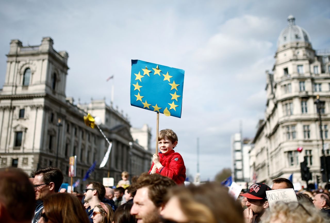 A boy holds an anti-Brexit sign while participating in the march in central London on March 23.