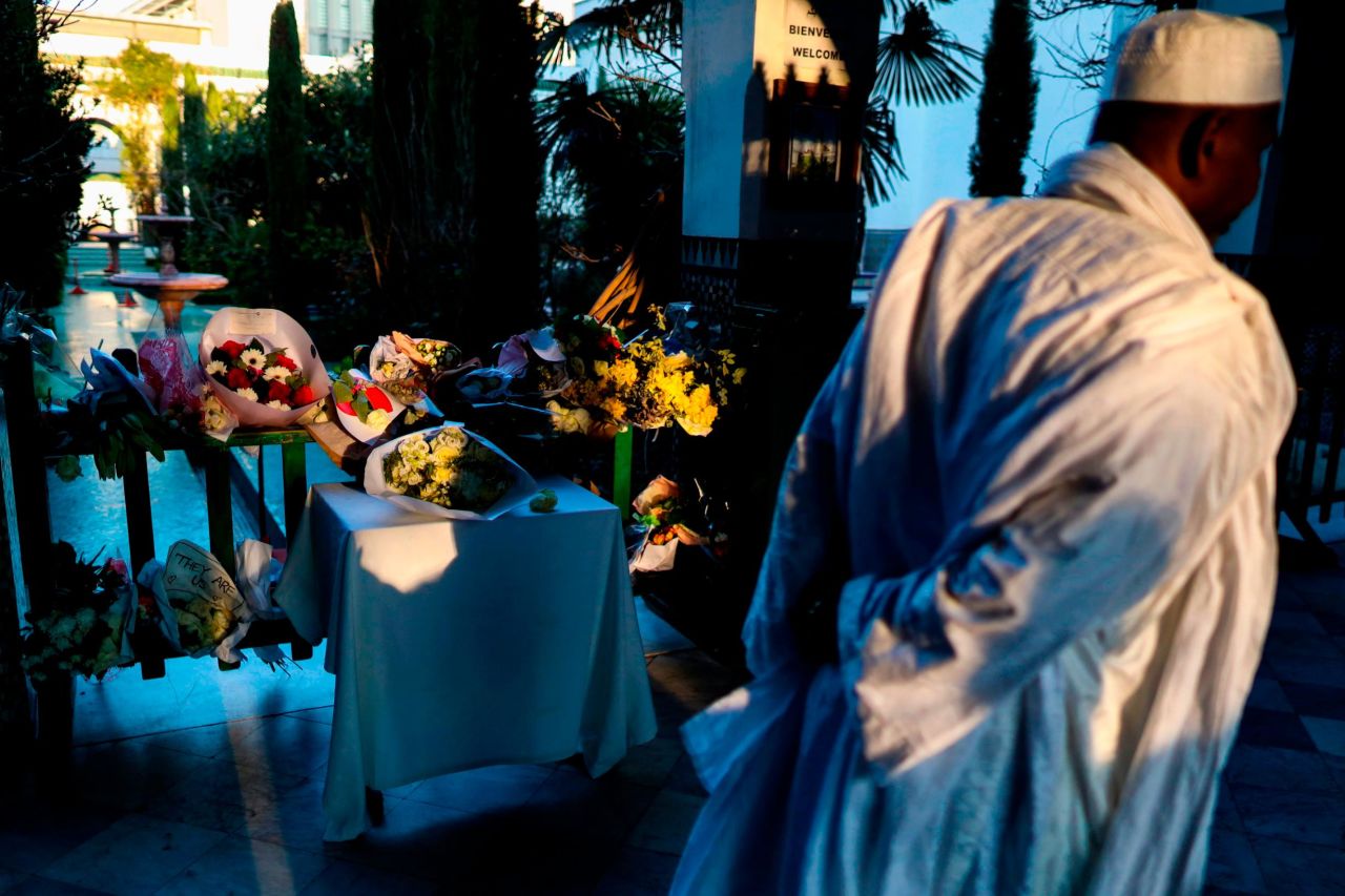 A man passes a makeshift memorial for the New Zealand victims at the Great Mosque of Paris on Friday, March 22.