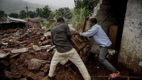 Men try to salvage appliances from a house damaged by the cyclone in Chimanimani, Zimbabwe, on March 23.
