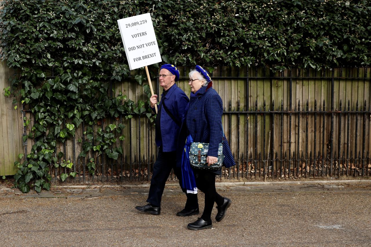 Two European Union supporters, wearing the color and stars of the EU flag, participate in the march in central London on March 23.