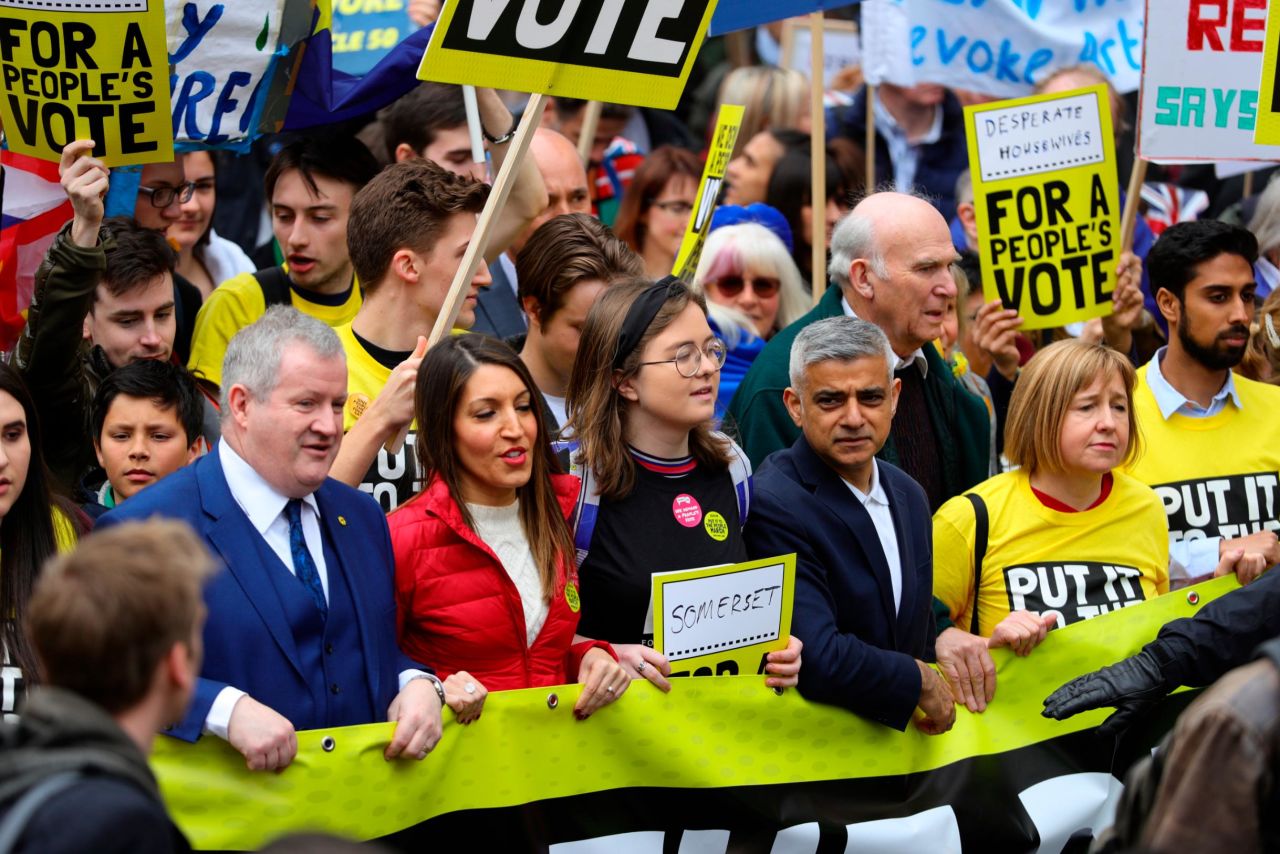 Member of Parliament Ian Blackford, left, and London Mayor Sadiq Khan, fourth from left, join anti-Brexit campaigners taking part in the march.