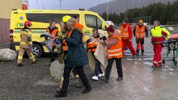 Passengers rescued from the Viking Sky cruise ship are helped from a helicopter in Hustadvika, Norway, Saturday March 23, 2019. A cruise ship with engine problems sent a mayday call off Norway's western coast on Saturday, then began evacuating its 1,300 passengers and crew amid stormy seas and heavy winds in a high-risk helicopter rescue operation. (Odd Roar Lange/NTB Scanpix via AP)