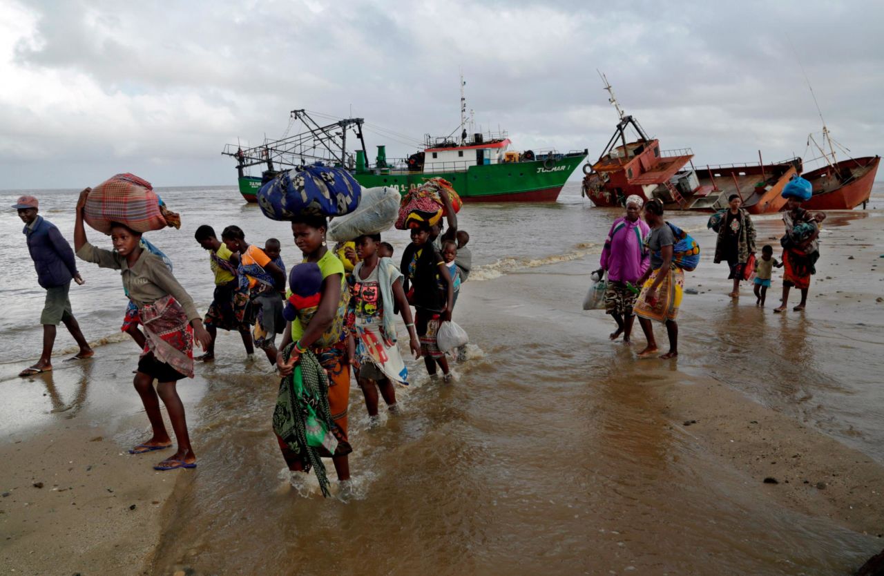 Displaced families arrive after being rescued from a flooded area of Buzi district in Mozambique on March 23.
