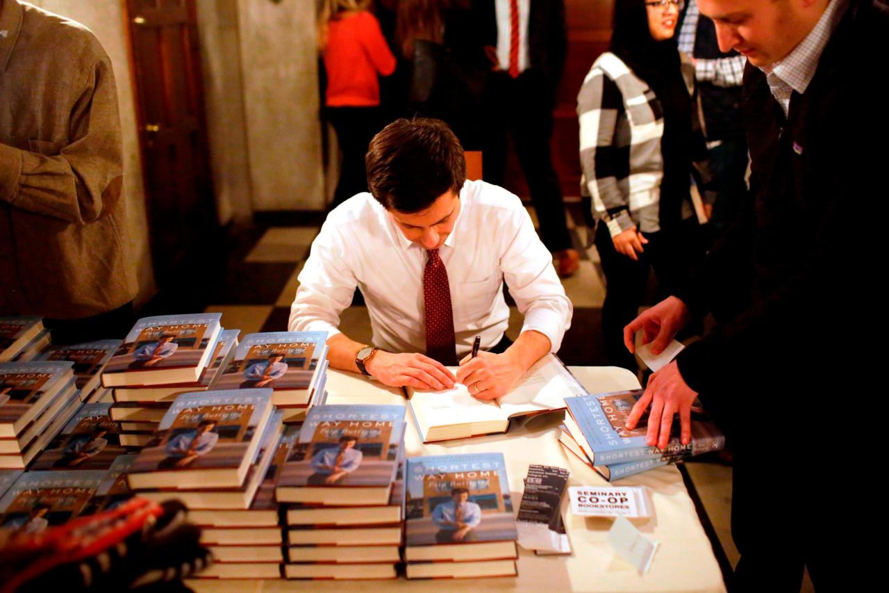 Buttigieg signs copies of his book "Shortest Way Home" in February 2019.