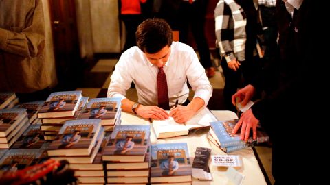 Buttigieg signs copies of his book "Shortest Way Home" in February 2019.