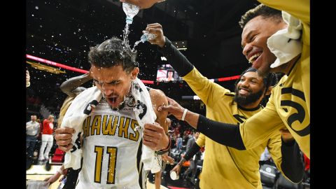 Trae Young (11) is doused by Atlanta Hawks teammates.