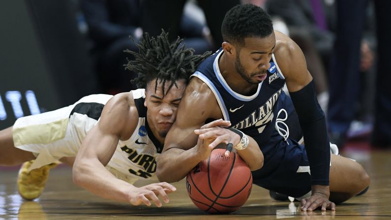 Purdue guard Carsen Edwards, left, and Villanova's Phil Booth dive for a loose ball during their second round game of the 2019 NCAA Men's Basketball Tournament in Hartford, Connecticut on Saturday, March 23. Purdue defeated Villanova to advance to the Sweet 16.