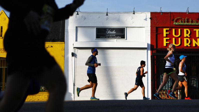 Runners jog up Sunset Boulevard during the 34th annual Los Angeles Marathon on Sunday, March 24.