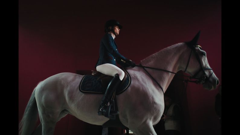 A rider and her horse enter the track prior to the Grand Prix Hermes International Jumping Competition at the Grand Palais in Paris on Sunday, March 24.