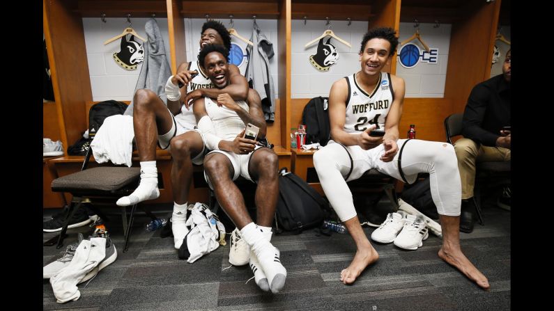 From left, Wofford Terriers teammates Chevez Goodwin, Tray Hollowell and Keve Aluma celebrate in the locker room after defeating the Seton Hall Pirates in the first round of the 2019 NCAA Men's Basketball Tournament in Jacksonville, Florida on Thursday, March 21.