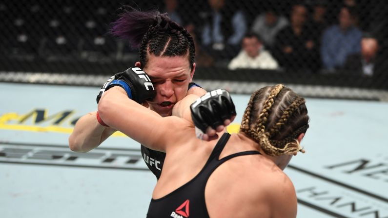Jennifer Maia, right, and Alexis Davis, left, exchange punches in their women's UFC flyweight bout at Bridgestone Arena in Nashville on Saturday, March 23.