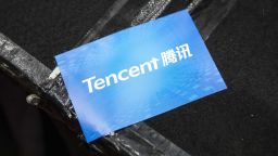 A sticker featuring the logo of Tencent Holdings Ltd. is seen during a news conference in Hong Kong, China, on Thursday, March 21, 2019. Tencent posted a quarterly profit that missed analysts estimates after it spent heavily on cloud and mobile payments businesses to offset a gaming slowdown. Photographer: Justin Chin/Bloomberg via Getty Images