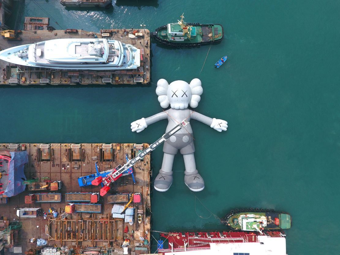 KAWS' new work lowered gently into the sea at the shipyards in Tsing Yi, Hong Kong.