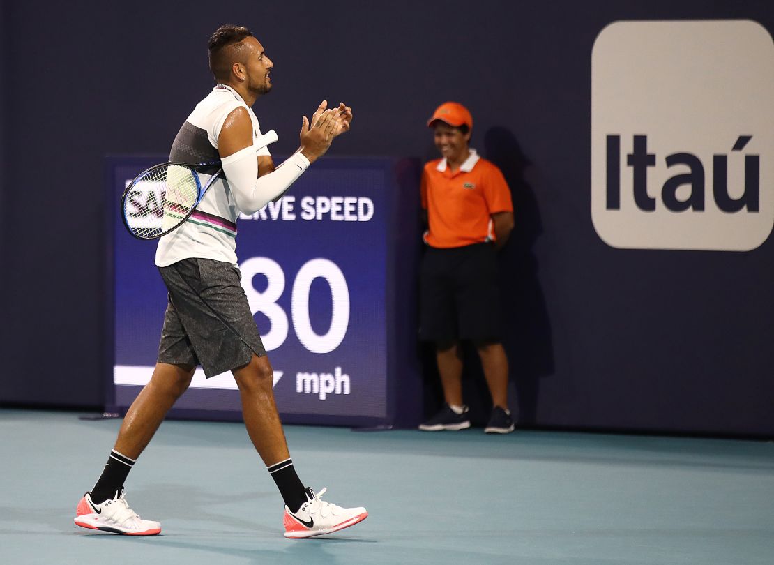 Kyrgios claps as the fan is shown off the court
