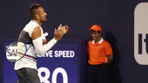 Kyrgios claps as the fan is shown off the court