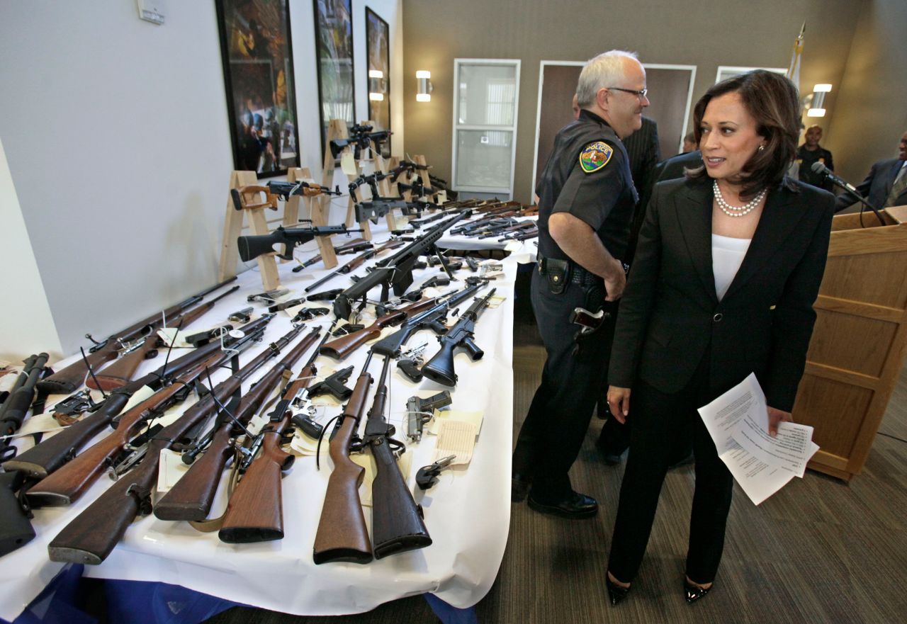 Harris looks over seized guns following a news conference in Sacramento, California, in June 2011. Harris became California's attorney general in January 2011 and held that office until 2017. She was the first African-American, the first woman and the first Asian-American to become California's attorney general.