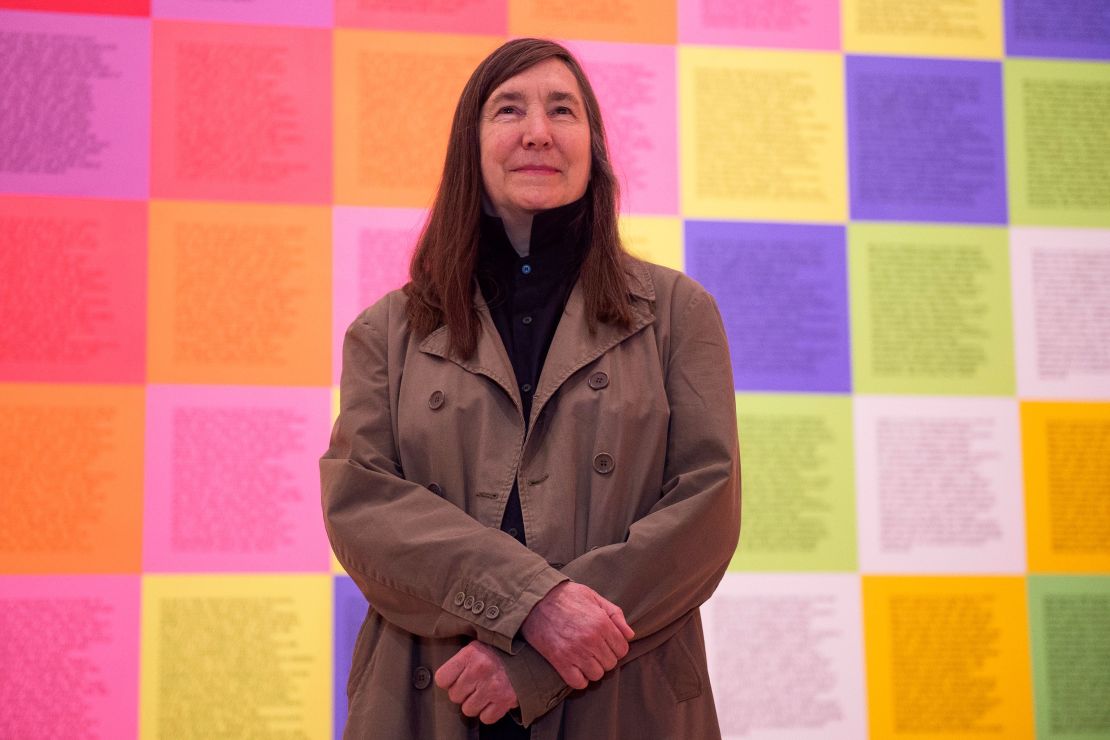 Jenny Holzer poses in front of her artwork "Inflammatory Wall" during a presentation of the "Jenny Holzer: Thing Indescribable" exhibition at the Guggenheim Museum in Bilbao, Spain. 