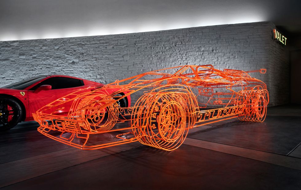 <strong>Don't drive this car. </strong>British artist Benedict Radcliffe's neon-orange wire-frame Lamborghini Twin Turbo Countach is "parked" in the main valet.