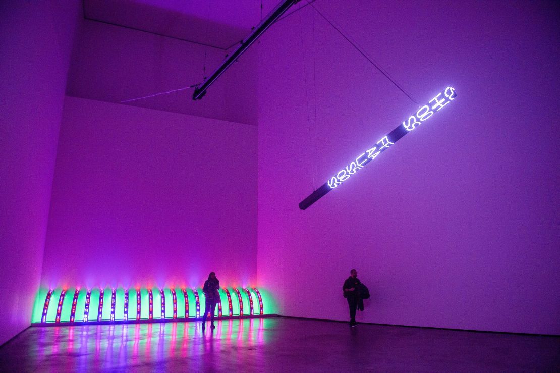 Visitors walk past "Purple" (on the floor) and "I Woke Up Naked" at the Guggenheim Museum in Bilbao. 