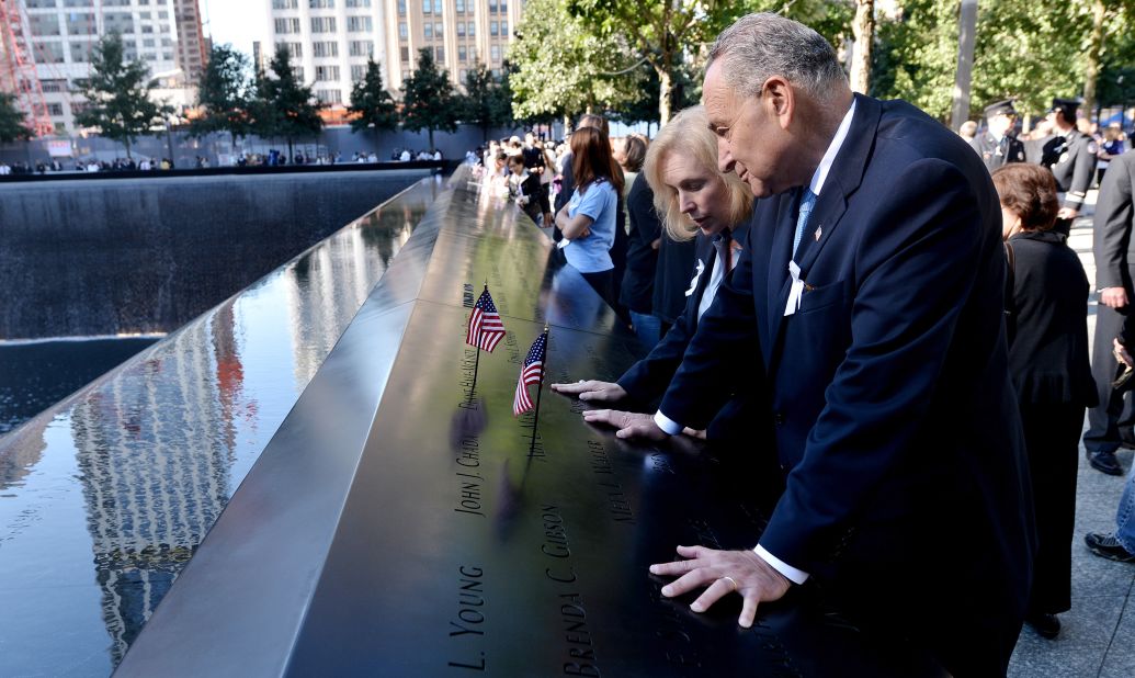 Gillibrand and Schumer place American flags at the reflecting pools of the World Trade Center Memorial in 2012.