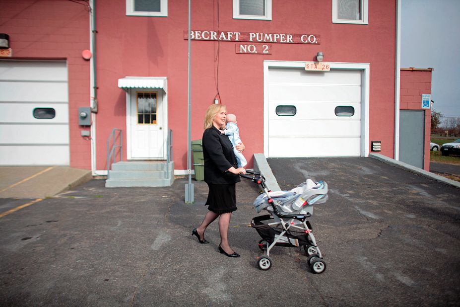 Gillibrand walks with her infant son, Henry, after voting in Greenport, New York, in 2008. She has two sons with her husband, Jonathan.