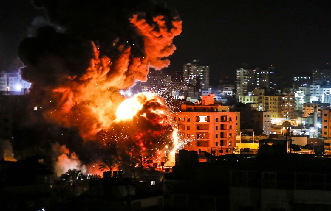 Fire and smoke billow above buildings in Gaza City during Israeli strikes on March 25.