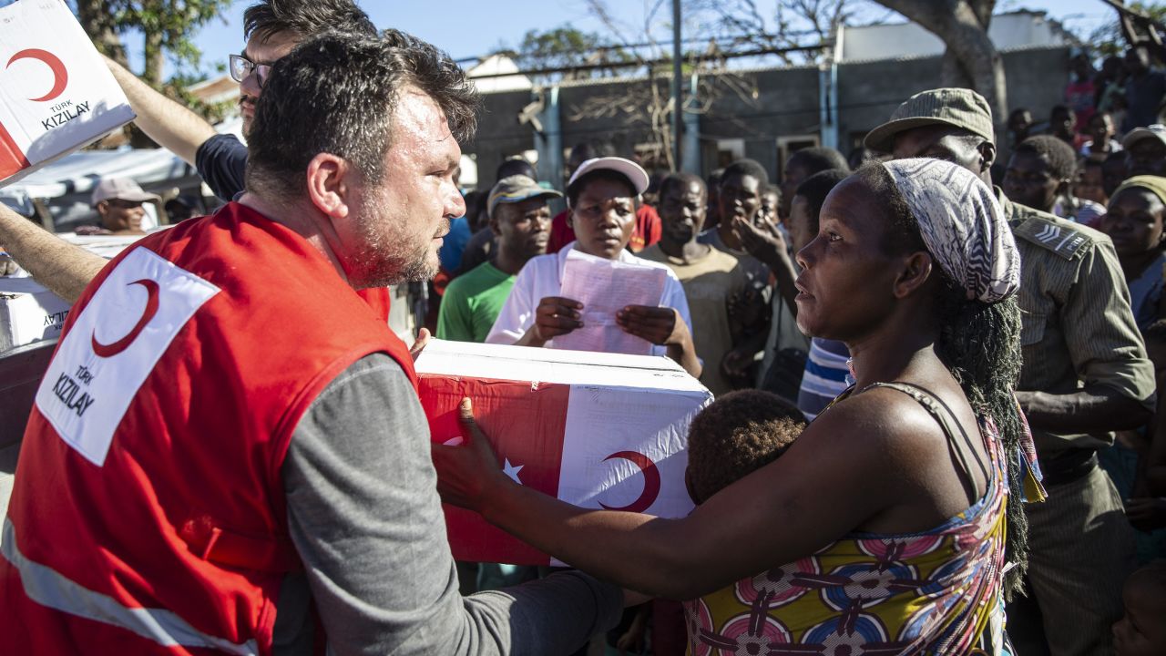 People receive supplies from a Turkish aid agency in Muabvi village of Beira, Mozambique, on Monday, March 25.