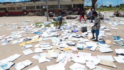 Children pick up books left to dry after Cyclone Idai damaged their school in Inchope, Mozambique, on March 25.
