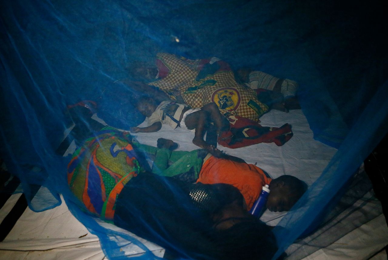 The displaced sleep under a mosquito net at a school housing survivors in Beira, Mozambique, on Sunday, March 24.