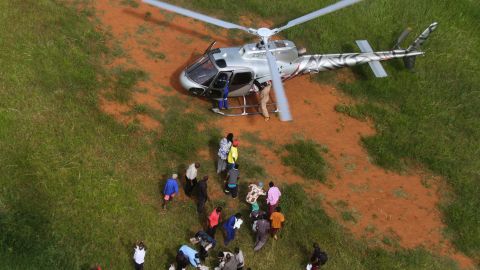 People unload relief supplies from a helicopter in Chimanimani, Zimbabwe, on March 24.