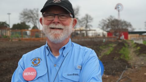 Mobile Loaves & Fishes founder Alan Graham stands in front of the organic farm in the heart of the Community First! Village.