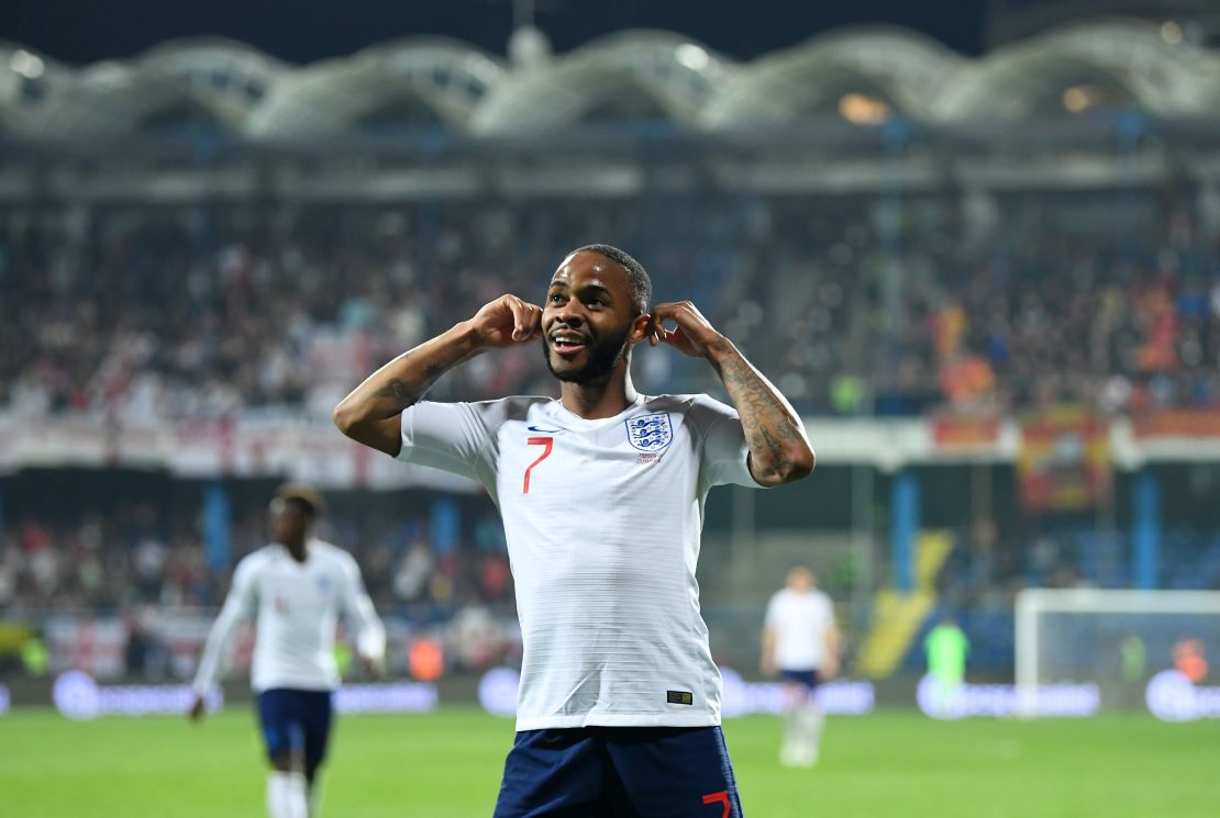 England's Raheem Sterling celebrates scoring against Montenegro by cupping his ears.