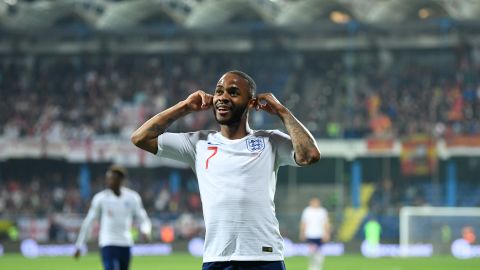 England's Raheem Sterling celebrates scoring against Montenegro by cupping his ears.