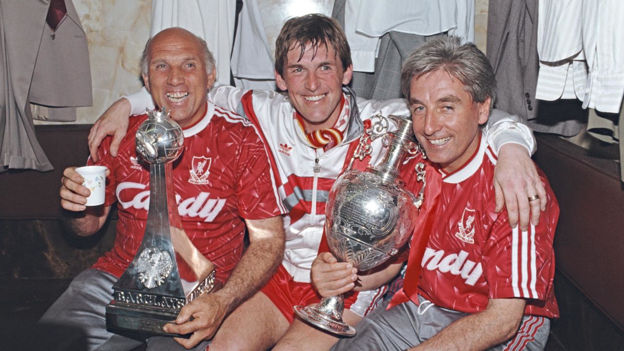 Liverpool player-manager Kenny Dalglish, center, on his final appearance as a player, Ronnie Moran, left, and Roy Evans celebrate the 1990 Division One Championship.