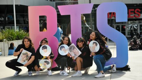Fans pose outside a BTS concert at the Staples Center in Los Angeles in September 2018. 