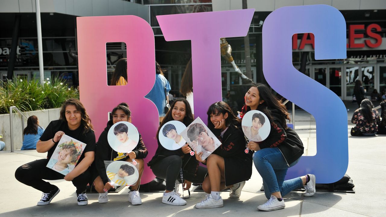 Fans pose outside a BTS concert at the Staples Center in Los Angeles in September 2018.