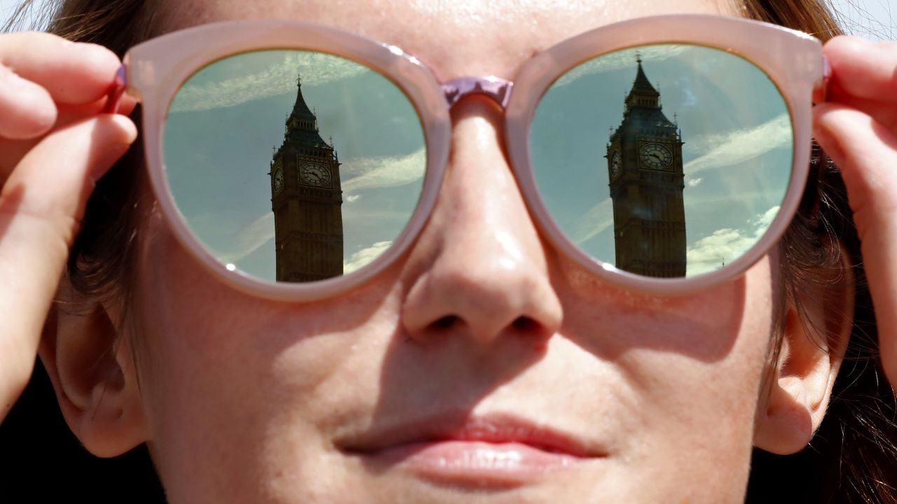 A tourist has the Elizabeth Tower, commonly referred to as Big Ben reflected in her mirror lenses as the sun shines in central London on June 16, 2017.
Britain and the European Union will start Brexit negotiations on Monday, while Prime Minister Theresa May nears a deal to prop up her minority government following her election fiasco. / AFP PHOTO / Tolga AKMEN        (Photo credit should read TOLGA AKMEN/AFP/Getty Images)