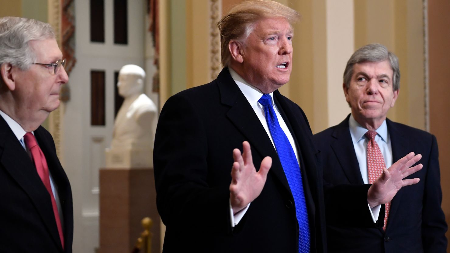 President Donald Trump accompanied by Senate Majority Leader Mitch McConnell of Ky., left, and Sen. Roy Blunt, R-Mo., right, speaks to members of the media as he arrives for a Senate Republican policy lunch on Capitol Hill in Washington, Tuesday, March 26, 2019. (AP Photo/Susan Walsh)