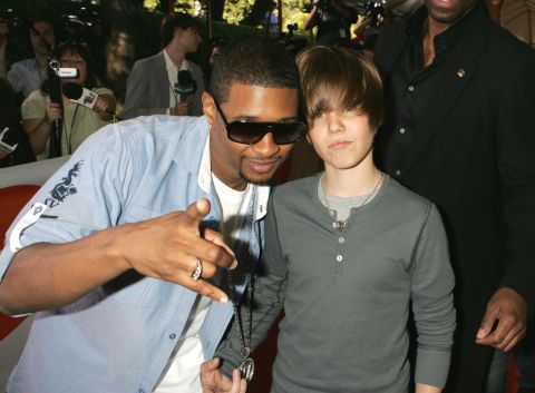 Bieber and R&B singer Usher attend the Kids' Choice Awards in March 2009. Bieber auditioned for Usher in 2008 and soon got a record deal.