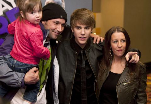 Bieber poses with his mother, Pattie Mallette; his father, Jeremy Bieber; and his sister Jazmyn before the screening of his 2011 film 