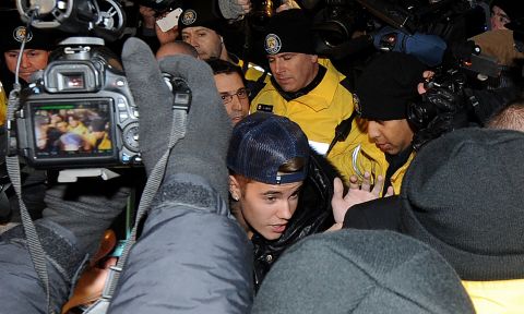 Days after his arrest in Miami Beach, Bieber appears at a police station in Toronto where he was charged with assaulting a limo driver in December 2013. <a href=