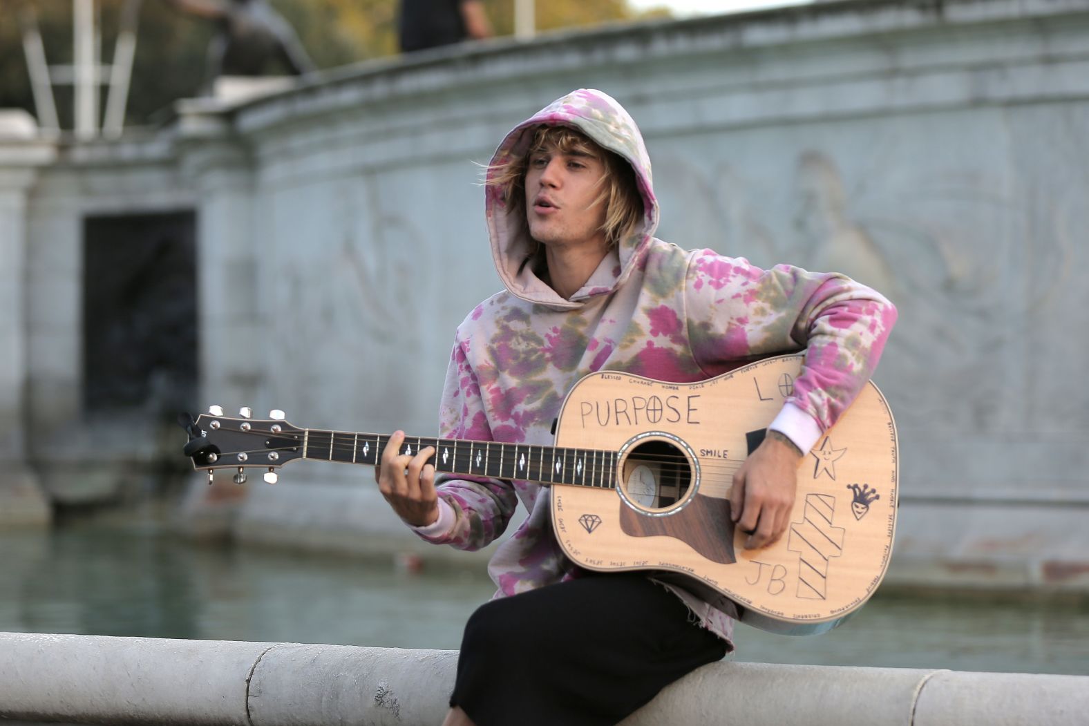 Bieber plays a guitar outside Buckingham Palace in London in September 2018. <a href="https://www.cnn.com/2018/09/19/entertainment/justin-bieber-hailey-baldwin-london-surprise-trip-intl/index.html" target="_blank">The unexpected performance</a> came while Bieber and Baldwin were out sightseeing. A small crowd gathered to watch his short acoustic set.